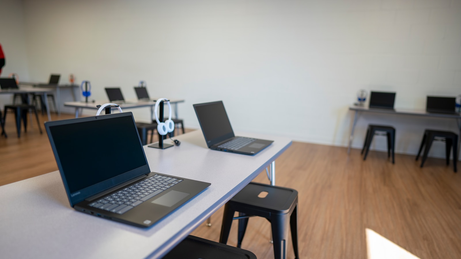 Laptops arranged for a classroom technology training session